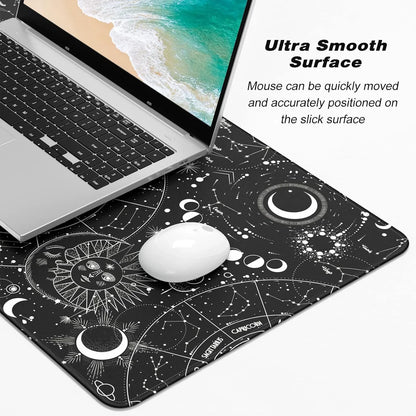Black space-themed mouse pad with zodiac constellation designs under a laptop and white mouse, highlighting ultra smooth surface