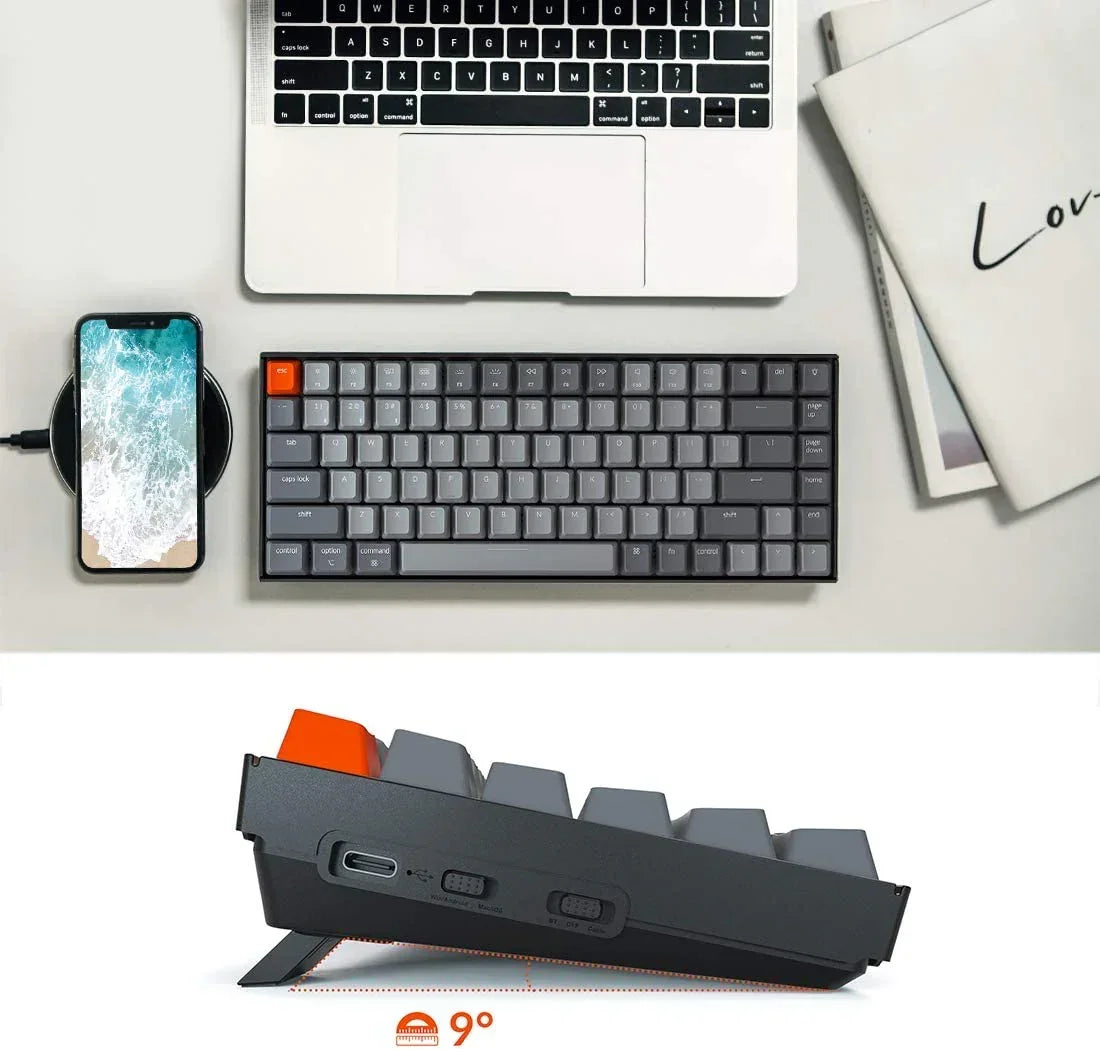 Compact mechanical keyboard with gray keycaps on desk beside laptop, phone, and notebooks, Byte Style gaming gear