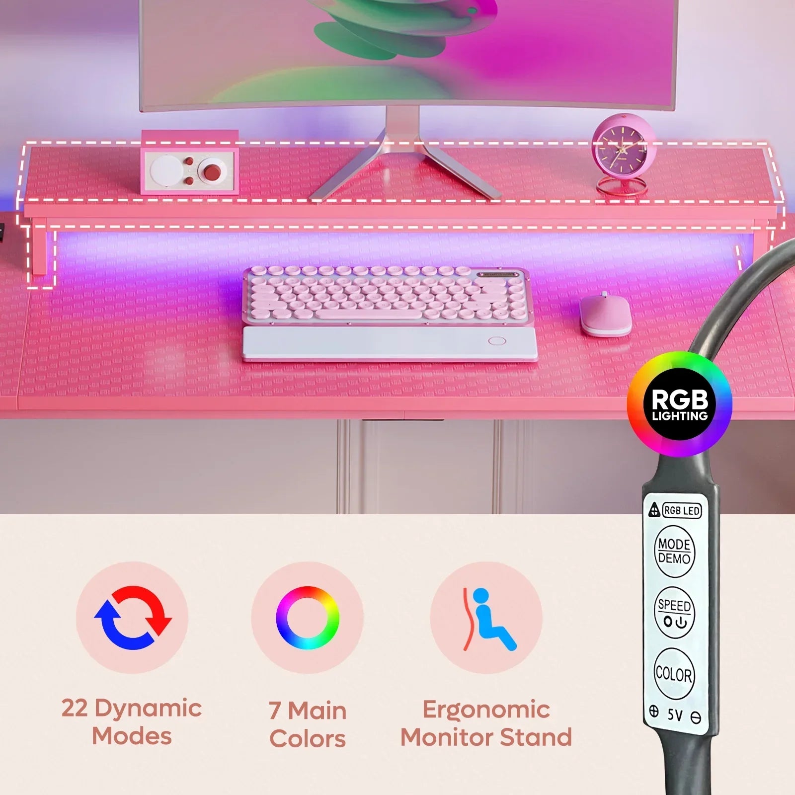 Pink gaming desk with ergonomic monitor stand, RGB lighting, pink keyboard, mouse, and clock