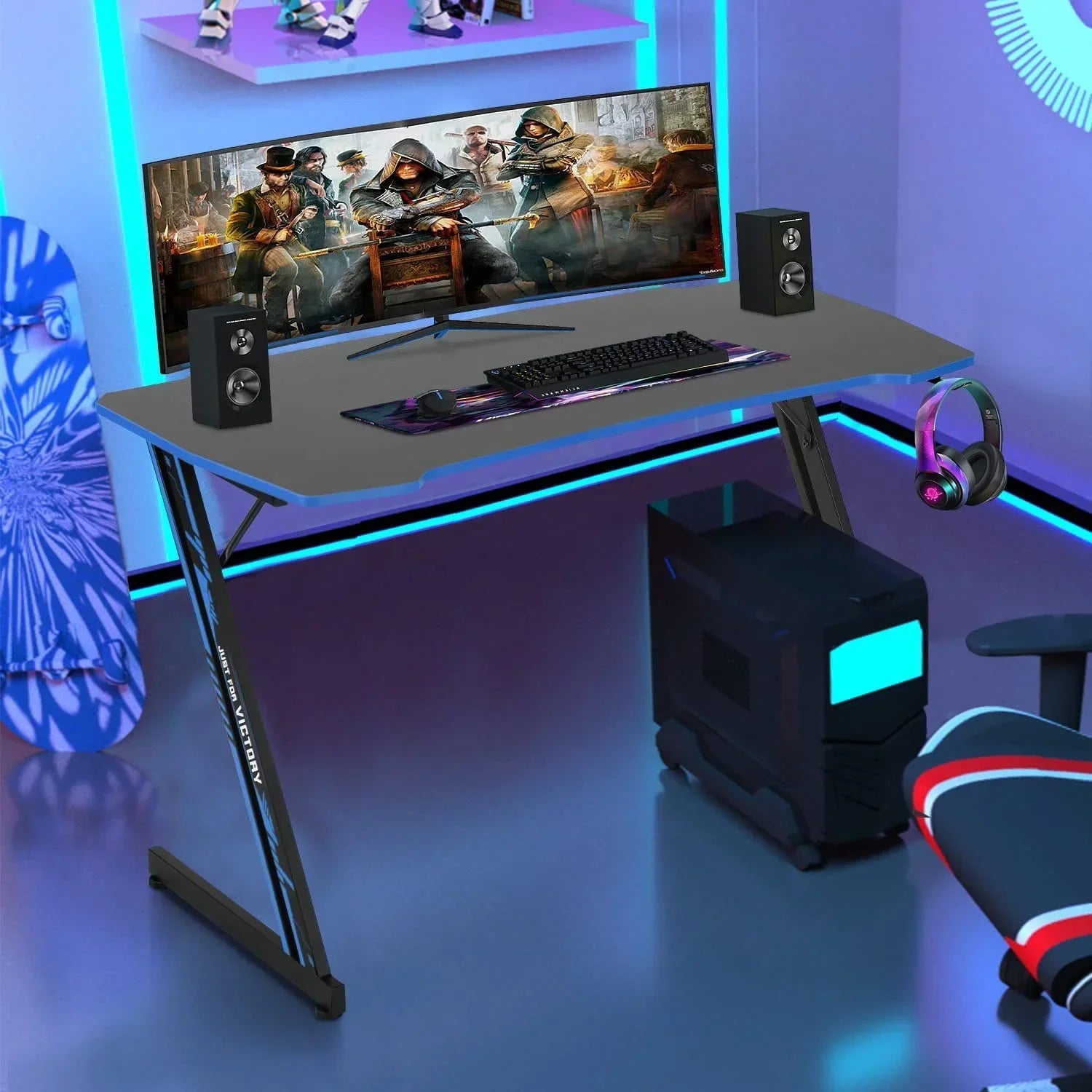 Modern gaming setup with curved ultrawide monitor, mechanical keyboard, mouse, speakers, gaming PC, RGB headphones on sleek desk