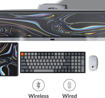 Modern gaming setup with Apple monitor, wireless mechanical keyboard, mouse, and tablet