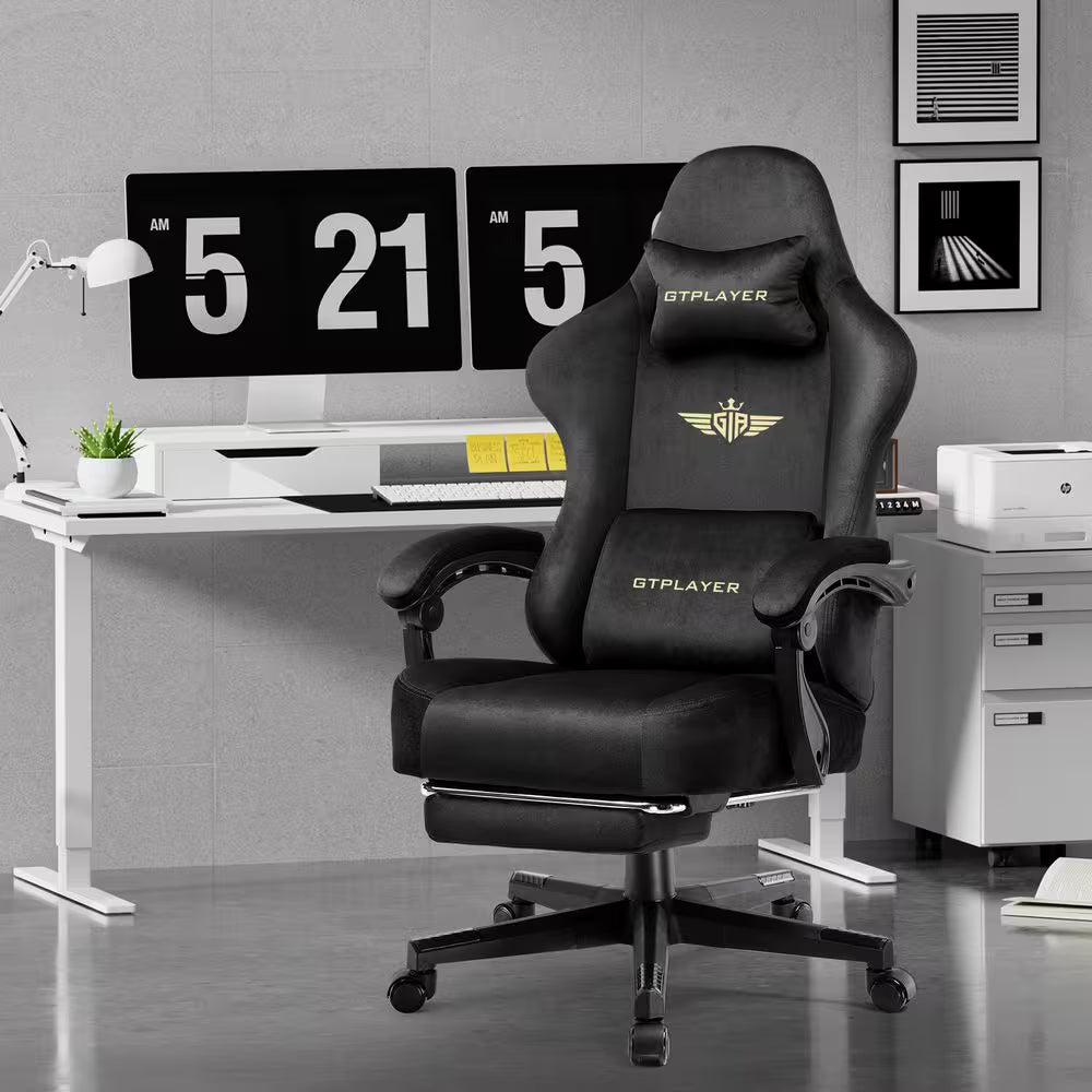 Black GTPLAYER gaming chair with gold logo, ergonomic design, and footrest in modern desk setup