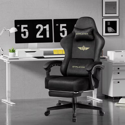 Black GTPLAYER gaming chair with gold logo, ergonomic design, and footrest in modern desk setup