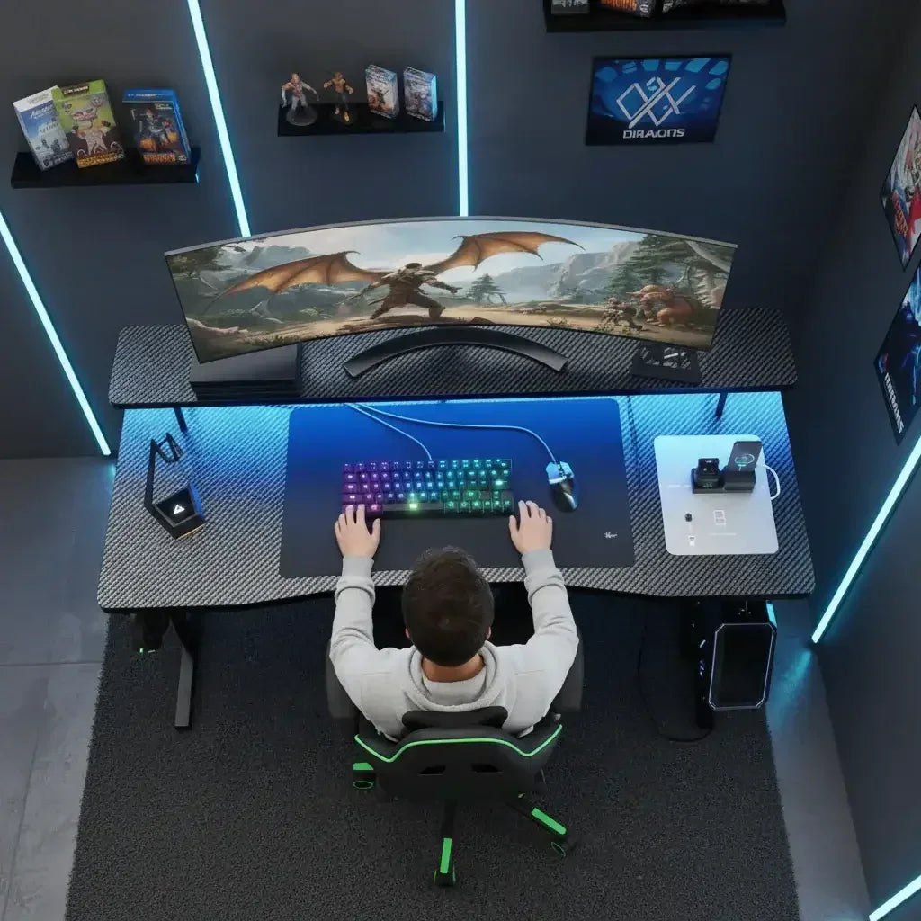 Top view of gaming setup with curved ultrawide monitor showing fantasy game, RGB keyboard, gaming mouse, and black desk