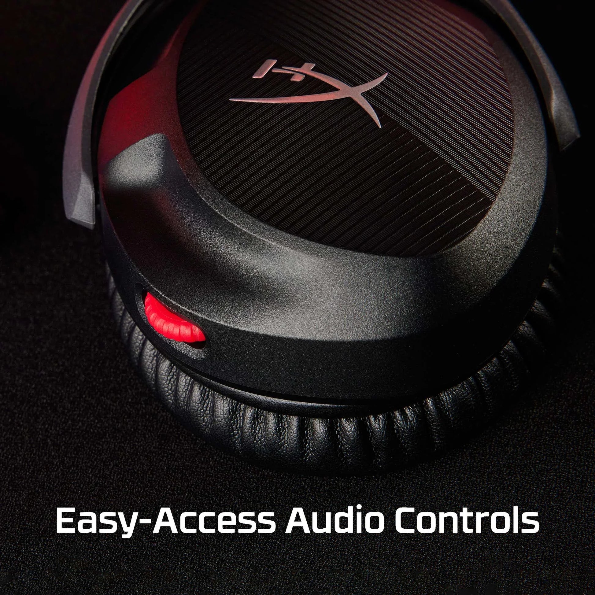 Close-up of HyperX headphones earcup with red audio control wheel on black background