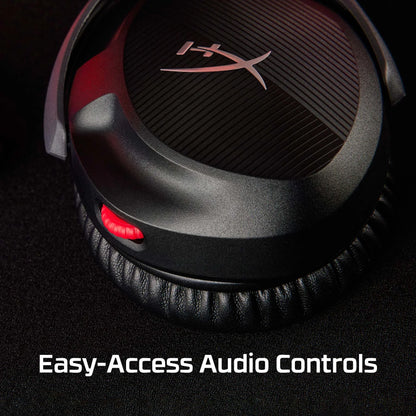 Close-up of HyperX headphones earcup with red audio control wheel on black background