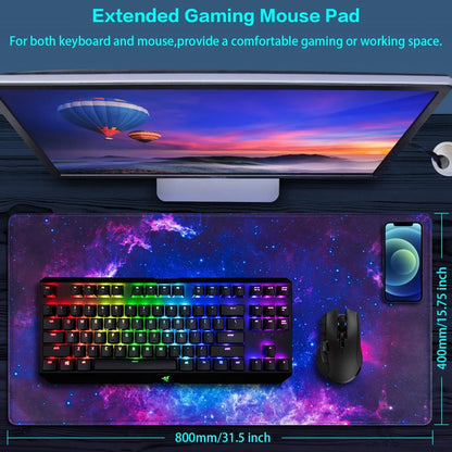 Extended gaming mouse pad with galaxy design, RGB keyboard, gaming mouse, and smartphone on black desk