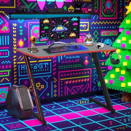 RGB gaming setup with mechanical keyboard, curved monitor, retro 8-bit neon decor, and PC tower