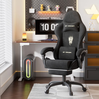 Black ST RACER gaming chair with flame logo, ergonomic design, in modern gaming setup with desk and monitor.