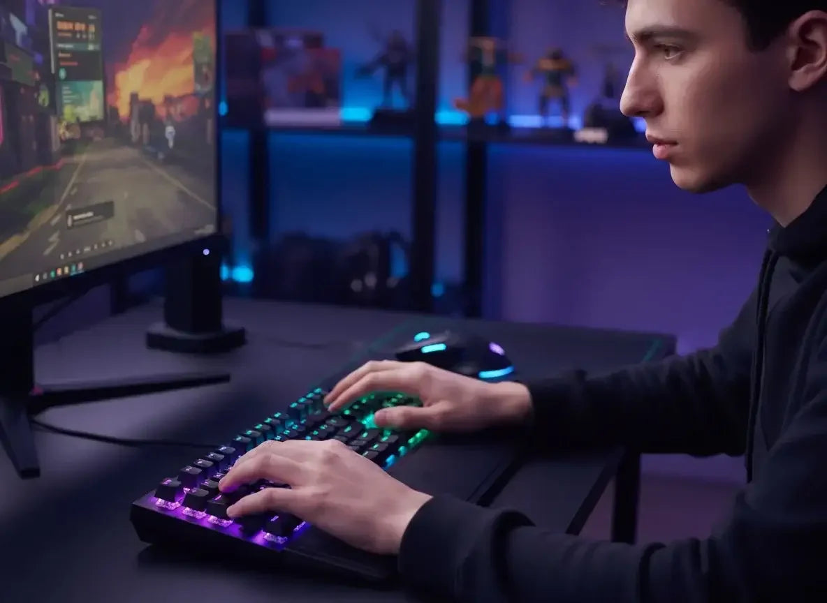 Young man focused gaming at desk with RGB mechanical keyboard and colorful game on monitor