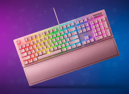 White wired mechanical keyboard with rainbow RGB backlighting and pink wrist rest on blue-purple background