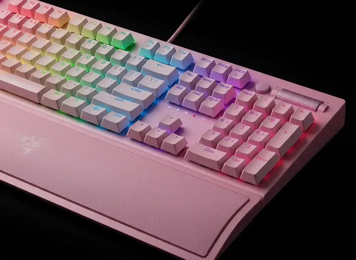 Pink mechanical gaming keyboard with RGB backlight and wrist rest on black background