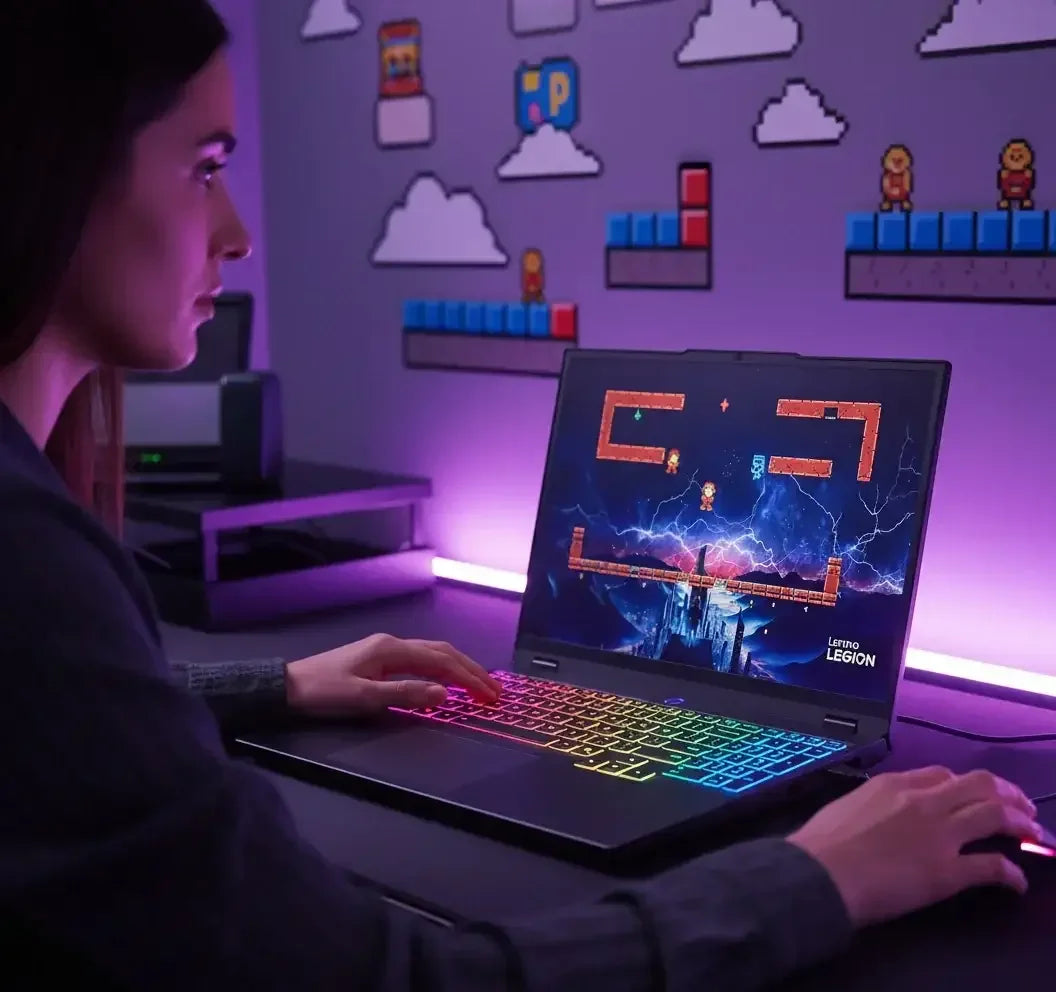 Woman gaming on Lenovo Legion laptop with RGB keyboard, pixel art wall decor, and purple lighting