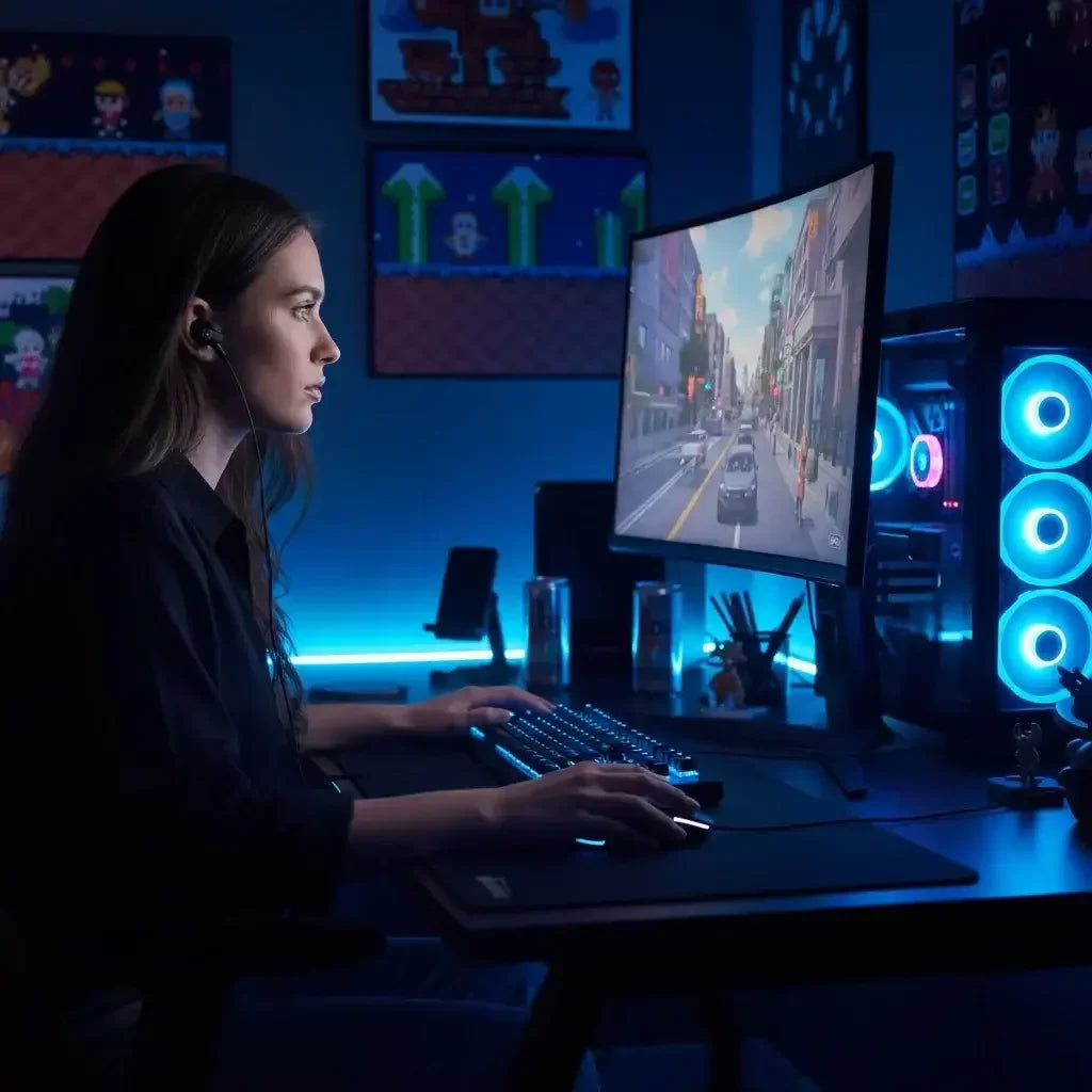 Focused gamer woman playing video game at RGB-lit PC setup with curved monitor in dark gaming room