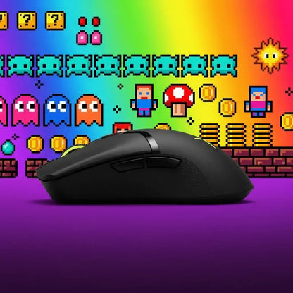 Black gaming mouse on purple surface with vibrant rainbow retro pixel art background featuring ghosts, coins, and characters