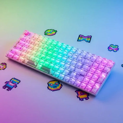 RGB backlit mechanical keyboard with transparent keycaps on pastel desk and pixel art stickers