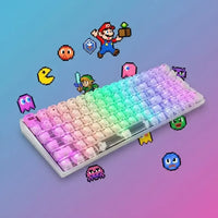 RGB mechanical keyboard with retro video game pixel art characters on a colorful gradient background