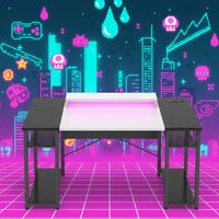 Modern gaming desk with LED lighting in front of a colorful pixel art city backdrop