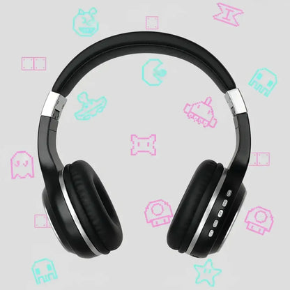 Black wireless headphones with silver accents on a gray background with pixel art gaming icons