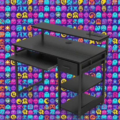 Modern black gaming desk with shelves and drawer against colorful pixel art video game character wall