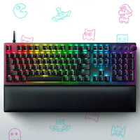 RGB gaming keyboard with wrist rest on white background, retro video game icons, vibrant lighting