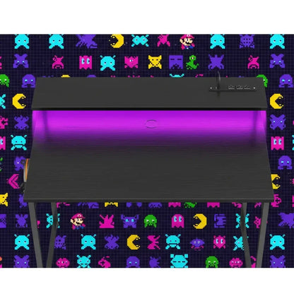 Black modern gaming desk with purple LED lighting against a colorful retro video game character background