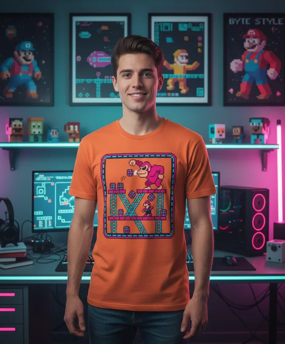 Young man wearing orange Donkey Kong pixel art T-shirt in a retro gaming themed room with pixel art posters and gaming setup