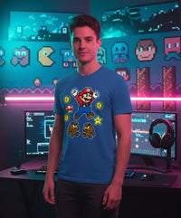 Man wearing blue Super Mario graphic t-shirt in a gaming room with pixel art and dual monitors