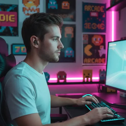 Man gaming at computer in neon-lit room with retro arcade posters and RGB keyboard