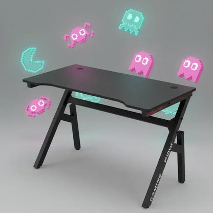 Black gaming desk with angled legs and retro 8-bit pixel art characters floating around