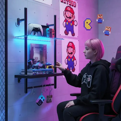 Girl with pink hair in gaming chair beside LED-lit wall shelf, gaming setup decor, pixel art posters