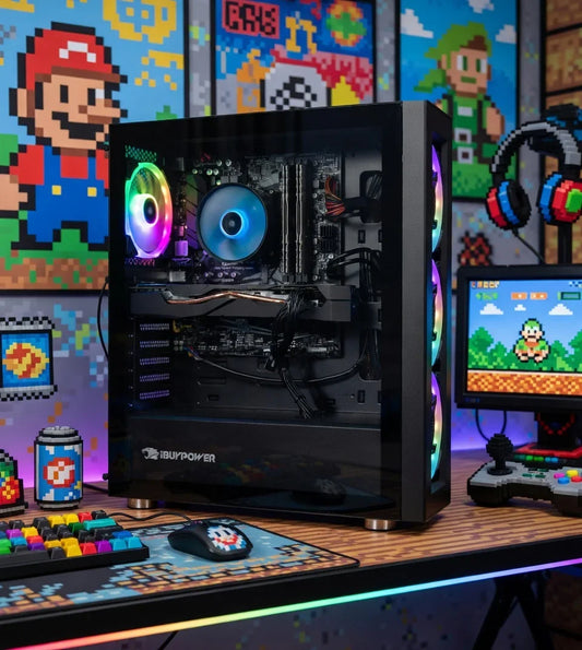 RGB gaming PC setup with colorful keyboard, mouse, and retro 8-bit gaming decor