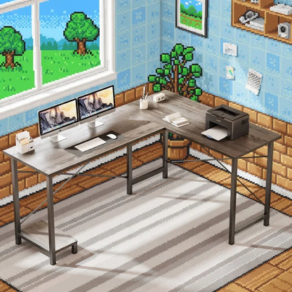 L-shaped gaming desk setup with dual monitors, keyboard and printer in a retro 8-bit pixel art room