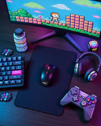 Retro 8-bit gaming setup with mechanical keyboard, mouse, headset, and pixel art monitor