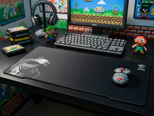 Retro gaming desk setup with 8-bit keyboard, pixel mouse, large mouse pad, and game cartridges