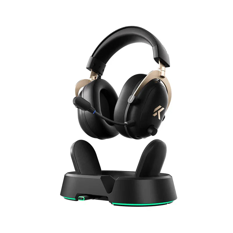 Black gaming headset with gold accents on charging dock, featuring RGB lighting and mic for PC setup