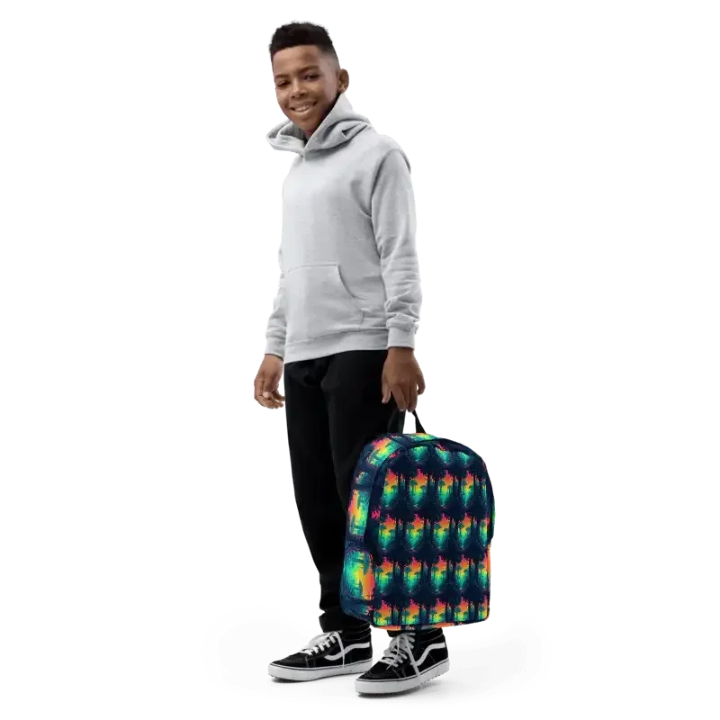 Smiling boy in gray hoodie and black pants holding colorful tie-dye patterned backpack