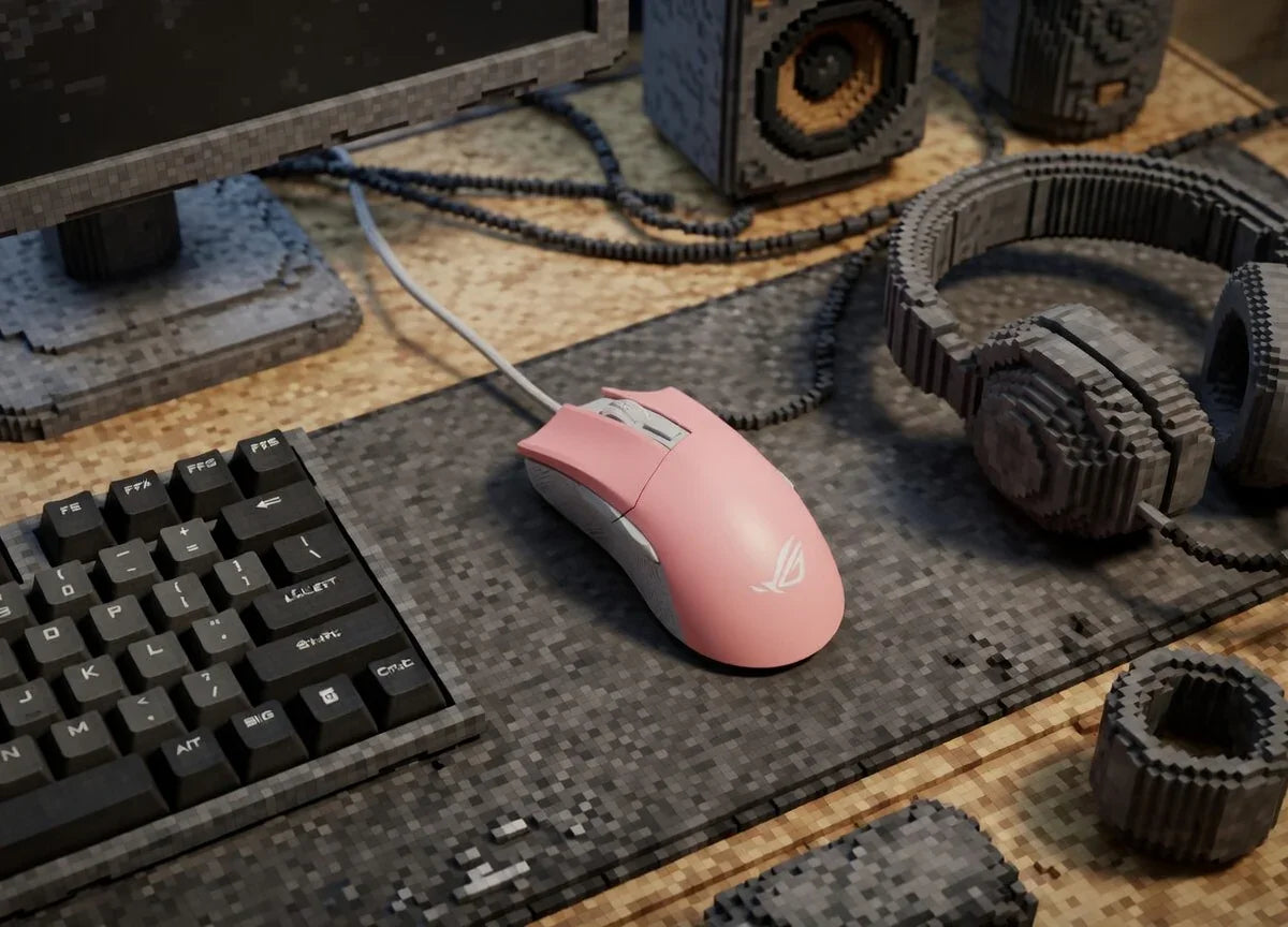 Pink gaming mouse on a pixel art style desk with keyboard, headset, monitor, and speakers