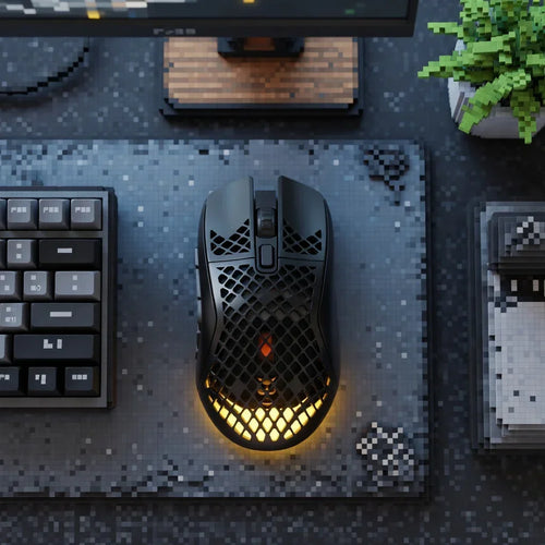 Gaming desk setup with black honeycomb mouse, RGB lighting, mechanical keyboard, and pixel art mouse pad